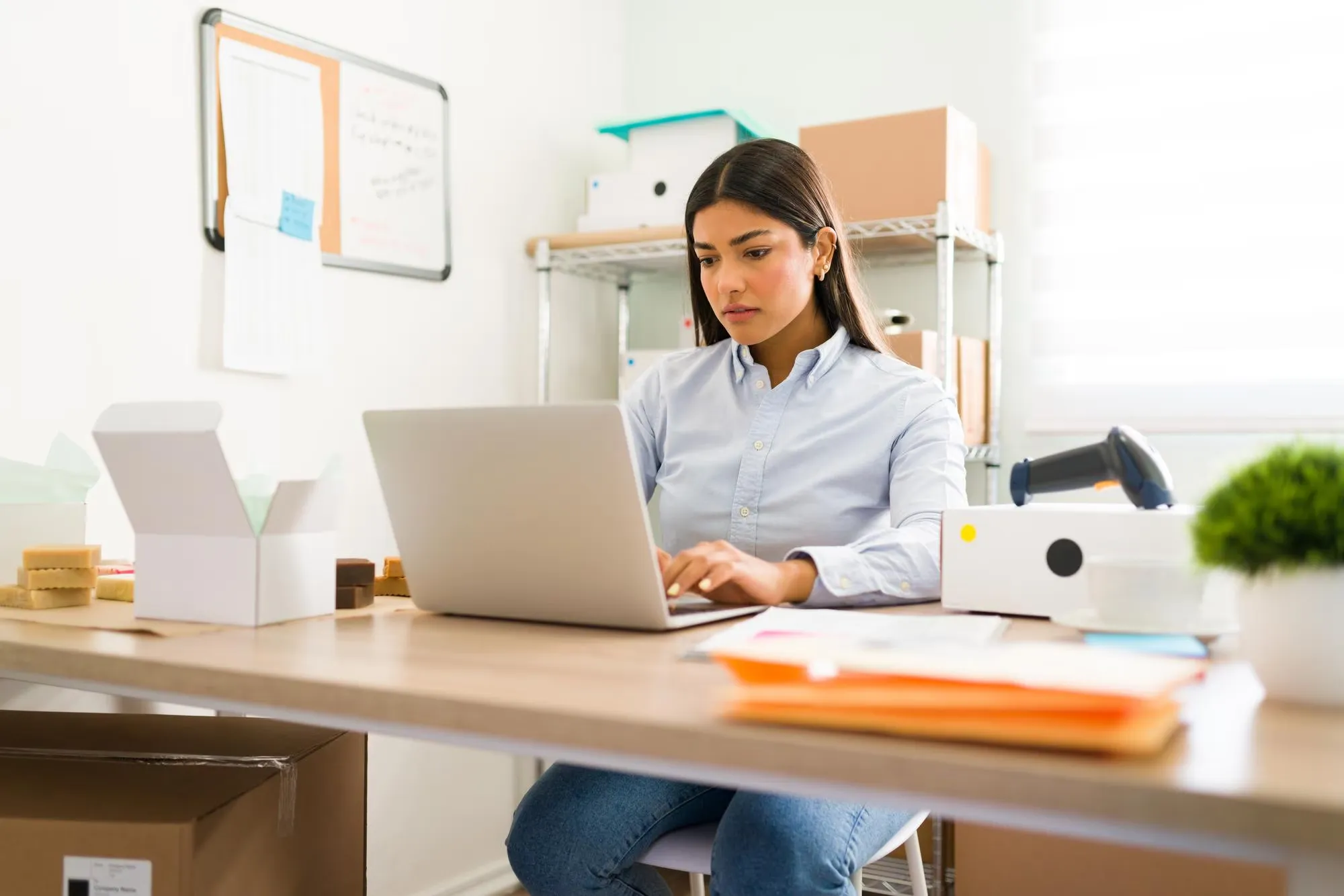 imgi_8_hispanic-young-woman-sitting-her-office-desk-working-wit